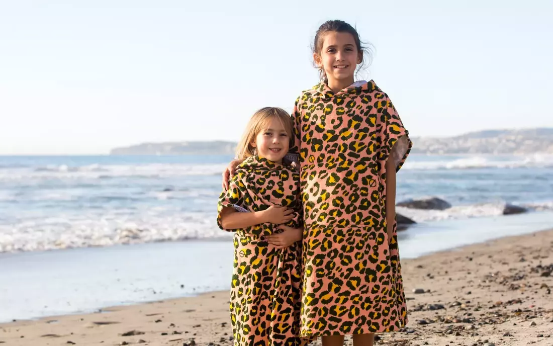 Kinder im Surf Poncho am Strand