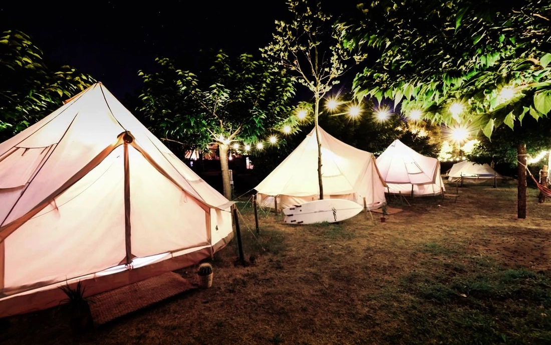 The cozy round tents at surf camp oyambre at night