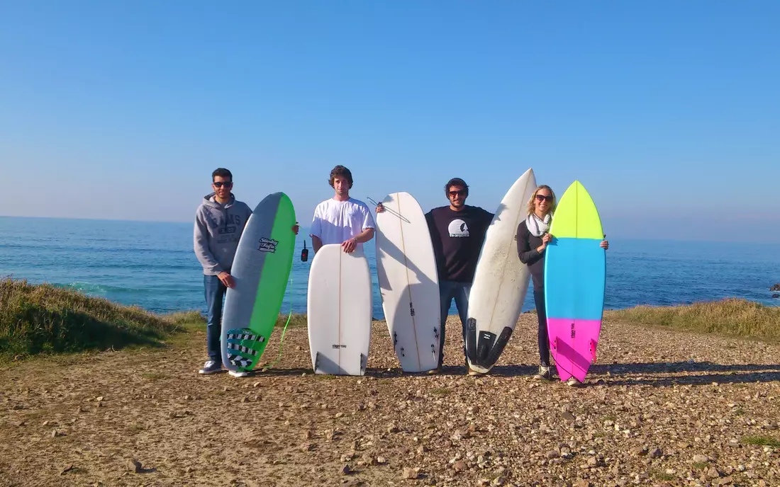 surfer with surfboards on a cliff in galicia