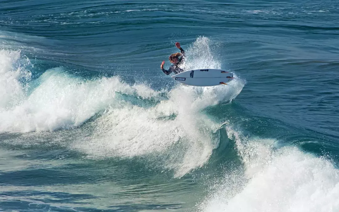 surfer surfing wave in the algarve