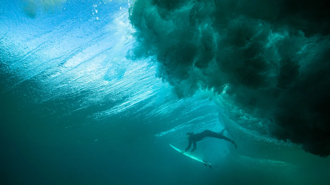 surfer with surfboard in the water