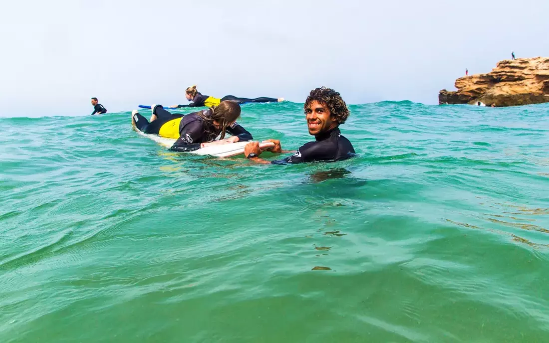 The surf instructors go into the water and give you tips