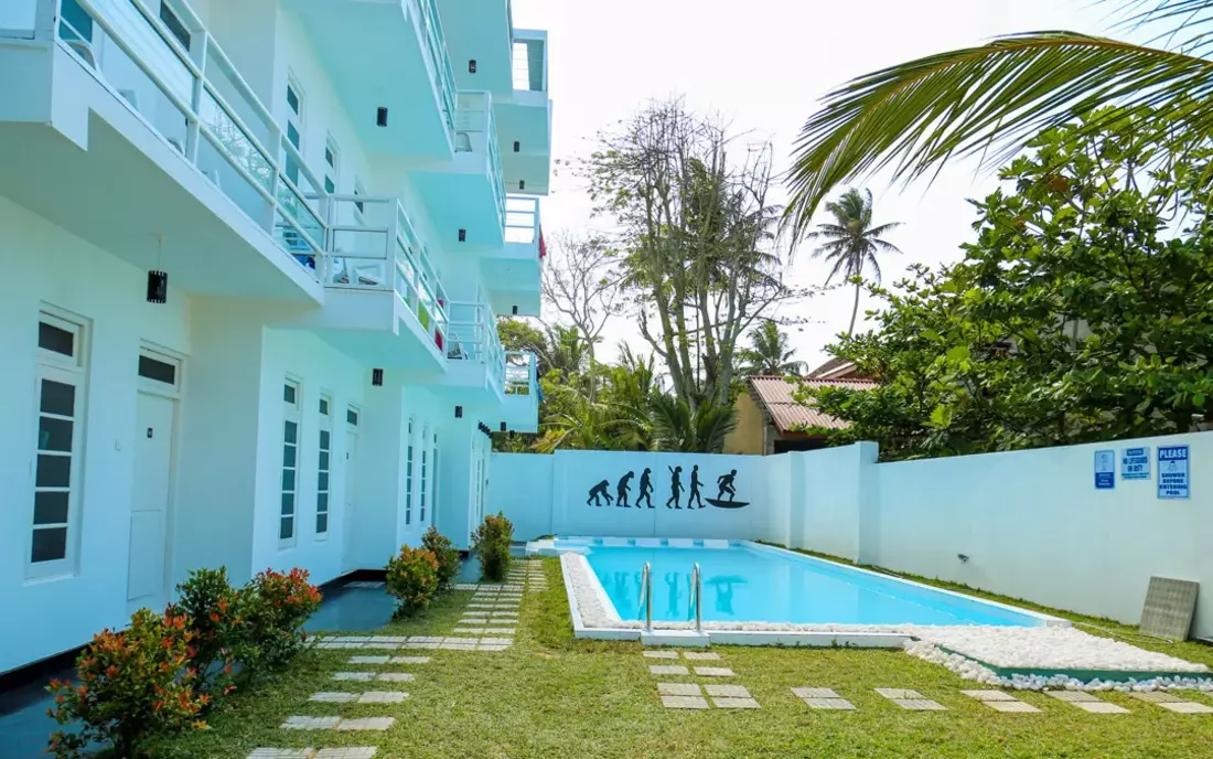 The pool surrounded by palm trees - Beachfront Surf House