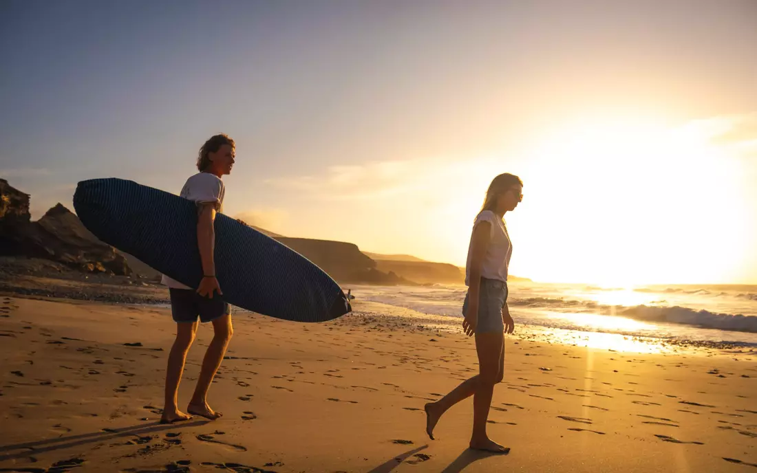 surfer with surfboards at the beach