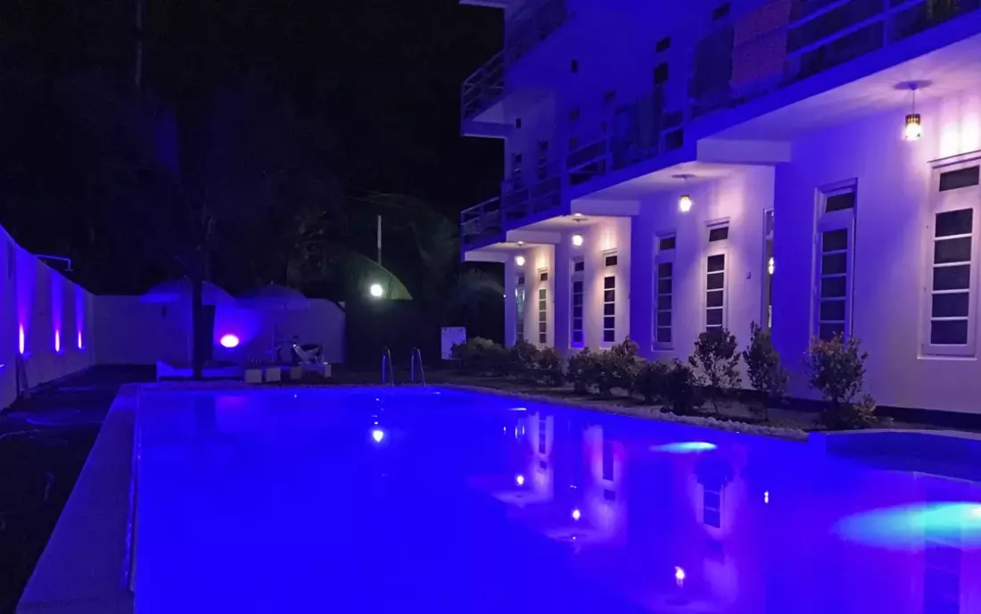 The Beachfront Surf House pool at night