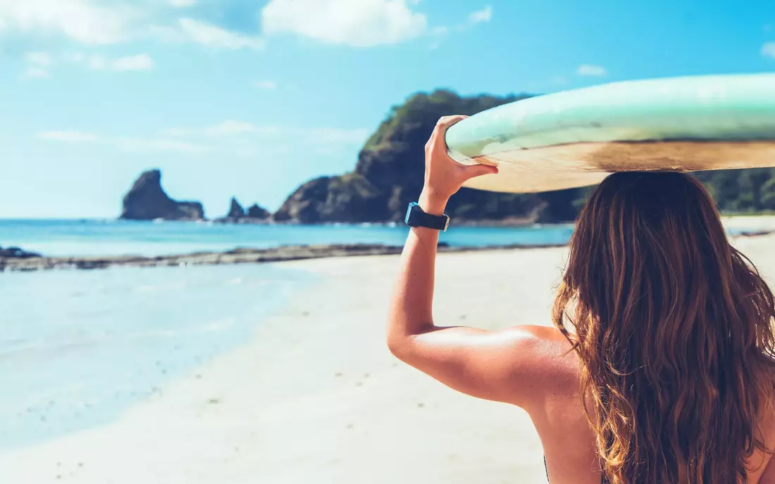 girl with surfboard at playa maderas