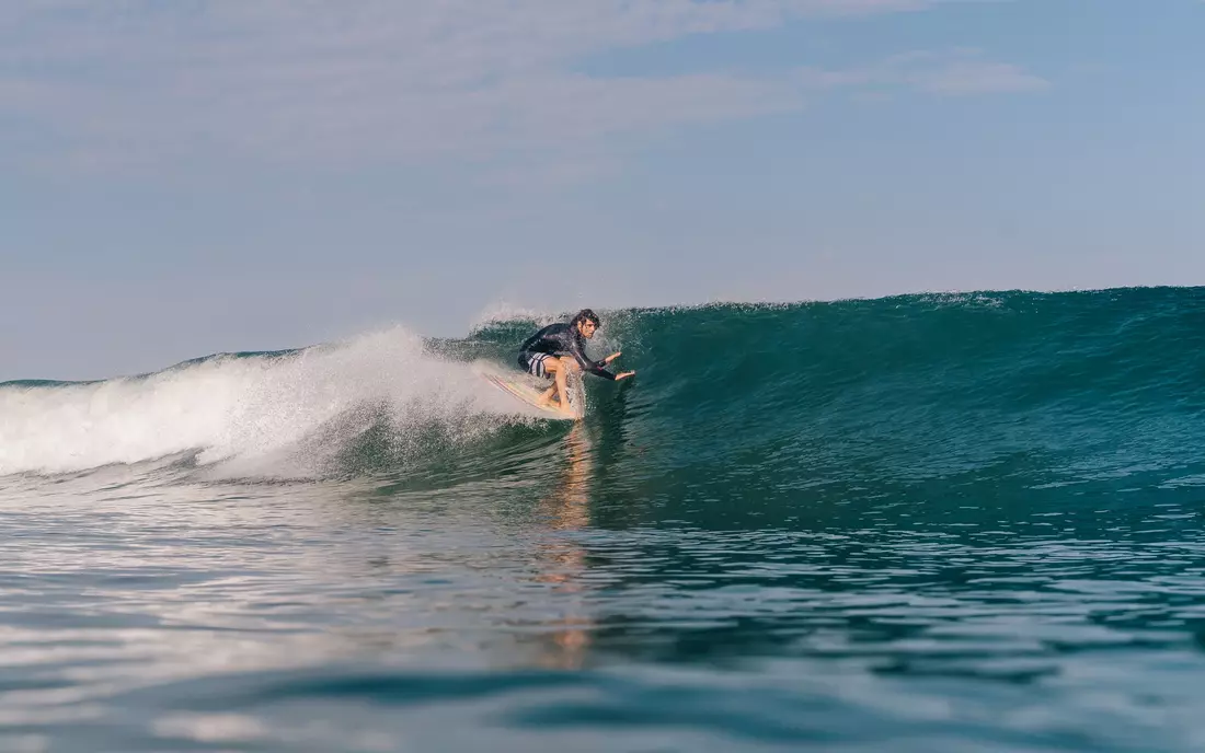 surfer surfing wave in the algarve