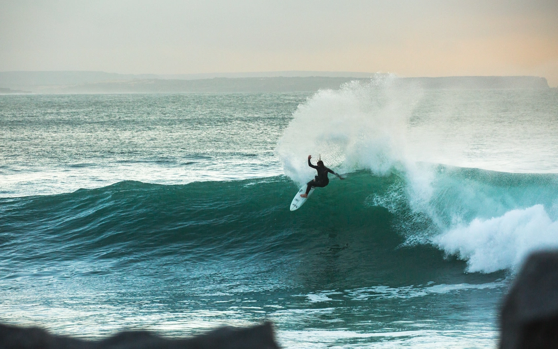 surfer surfing wave in the algarve