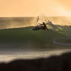 surfer surfing wave at surf spot in morocco