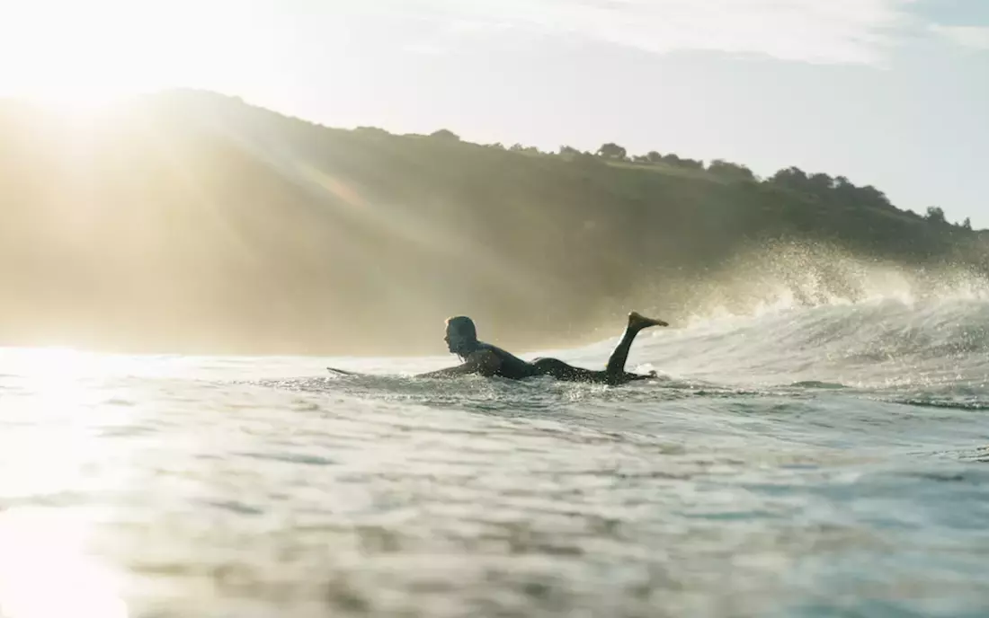 surfer paddling in the ocean