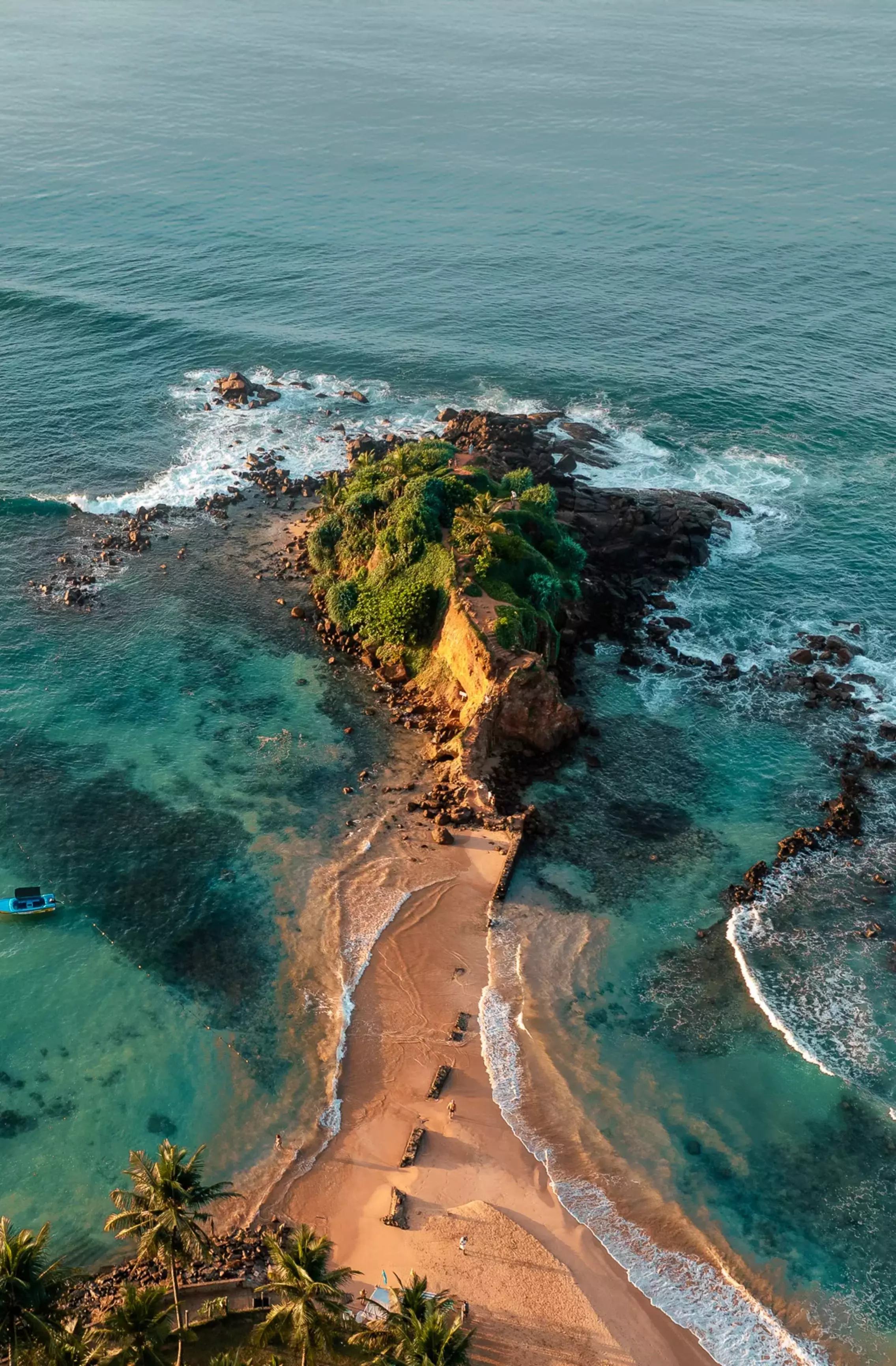 Waves from above breaking on a peninsula headland