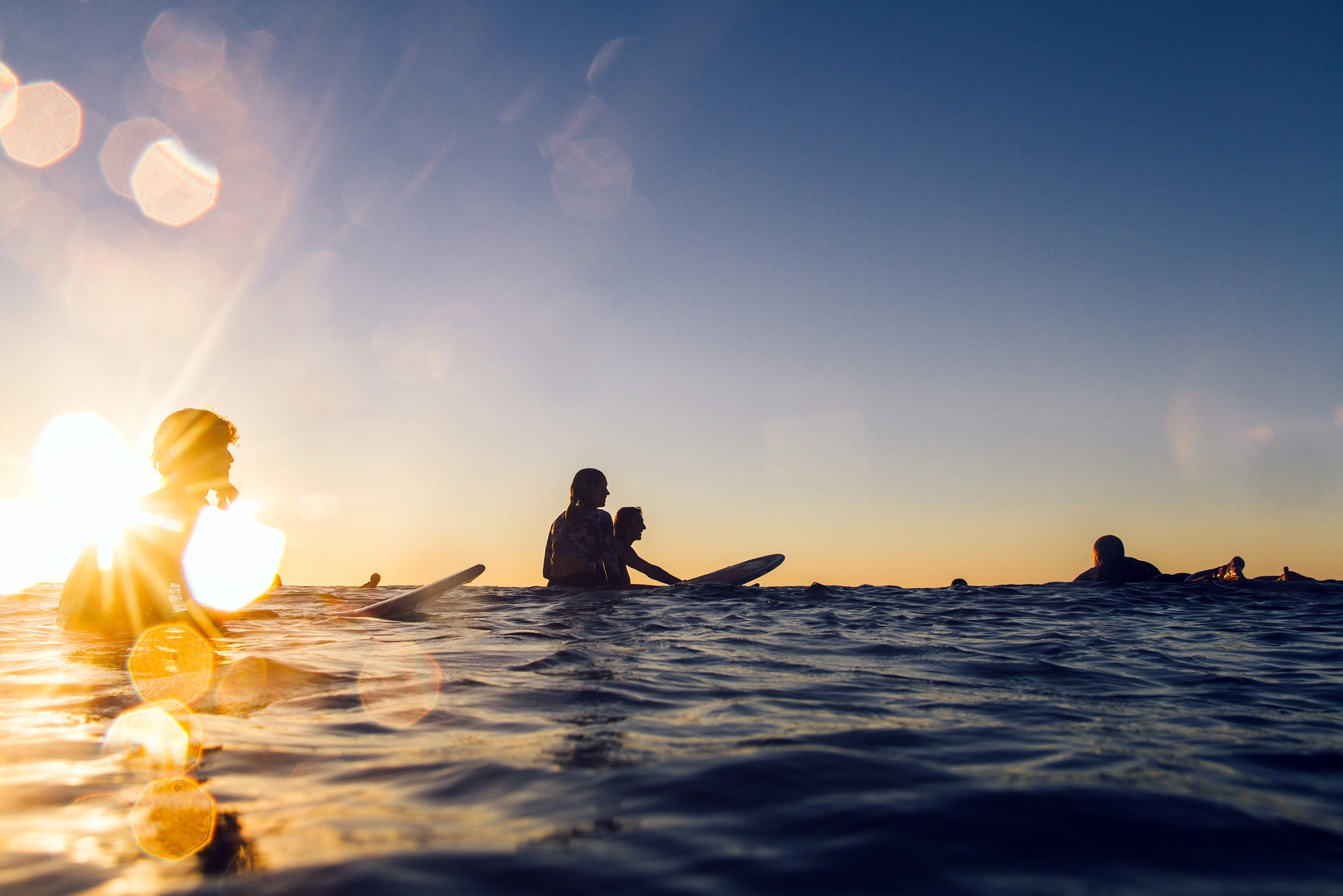 surfer sitting on surfboards in the ocean