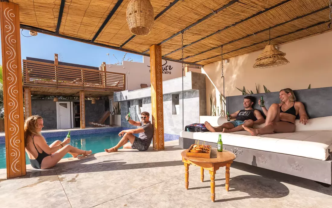 surf camp guests at the pool of the sea view surf camp morocco