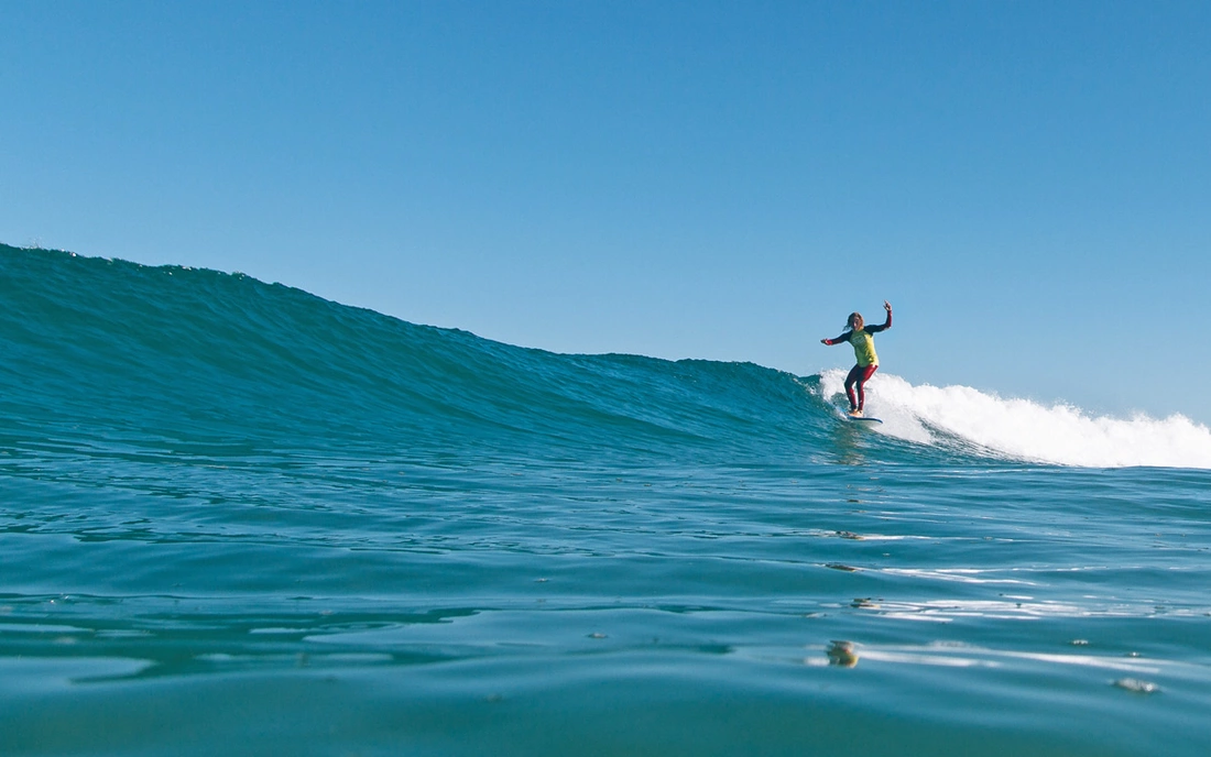 Surf longboarder walking the plank