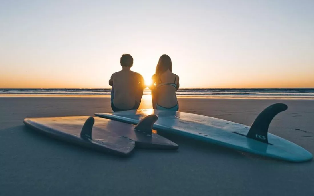 Surfing couple retro surfboards